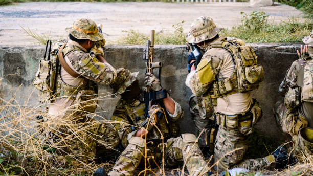 istock Smart teamwork of soldiers running forward and attacking enemy during military operation, Army soldiers in protective combat uniform, Soldiers with rifle, Soldiers with rifle on world war field 1517502348