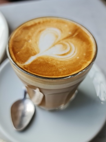 Latte art is the skillful and artistic pouring of steamed milk into a shot of espresso to create visually appealing patterns or designs on the surface of the coffee