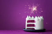 Purple birthday celebration cake with sparkler