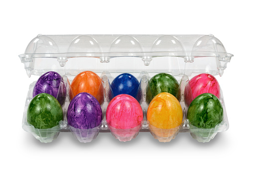 Multi colored easter eggs colors in transparent egg carton container packaging