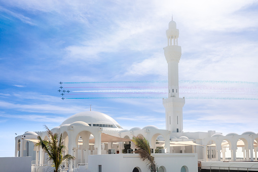 Fighter Jets Squadron with smoke traces over Alrahmah mosque, Jeddah, Saudi Arabia