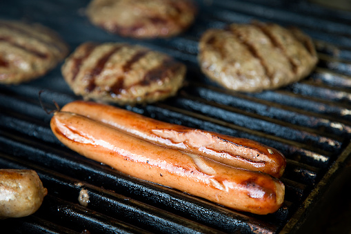 Grilling meat on an outdoor barbecue grill.