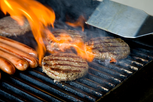 Grilling meat on an outdoor barbecue grill.