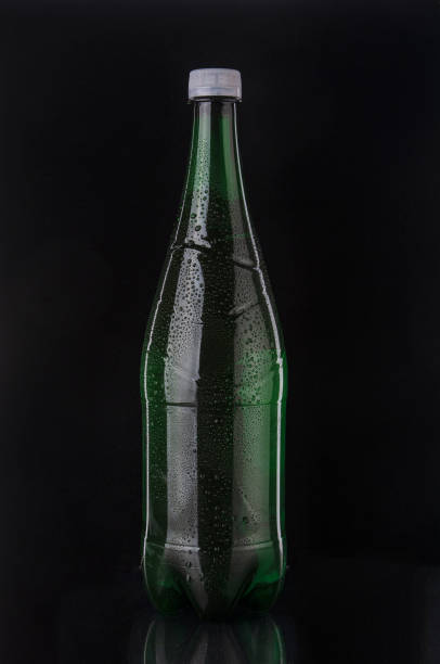 istock Soda drink bottle close up on black background 1517627617