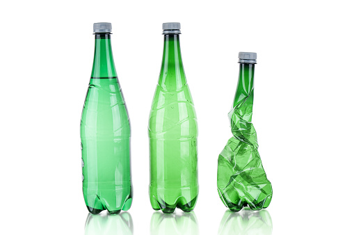 Plastic bottles soda water and wrinkled bottle on white background
