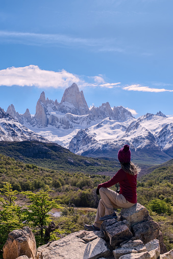 Young Woman sitting on the point view overlooking Mount Fitz Roy