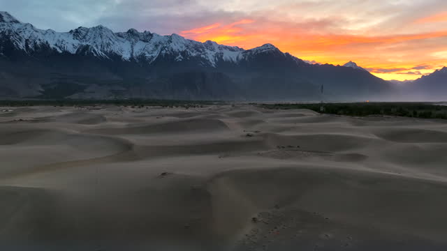 Clouse up Aerial drone sunset view of Katpana cold desert surrounded by snow cap mountain from Karakoram range, Skardu, Northern of Pakistan