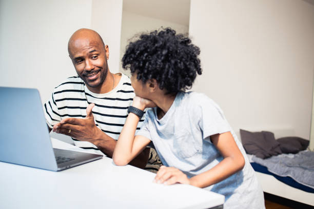 istock Young man works from home with his son by his side 1517731838