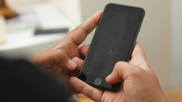 istock a man is using his cell phone for e-commerce shopping, playing social media, and browsing at his house. 1517785162