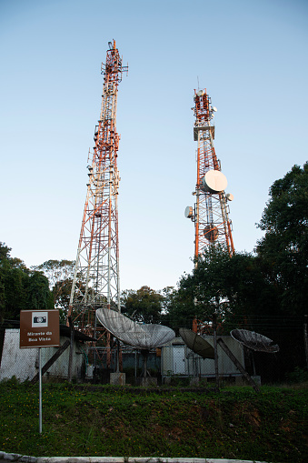 two towers of radio and television telecommunication antennas in an urban environment