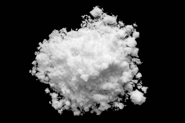 istock White snow isolated on black background close up 1517908038