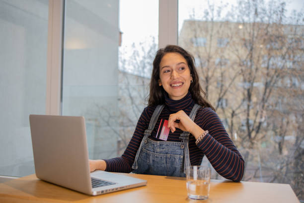 istock Cheerful  young woman doing online shopping 1517908043