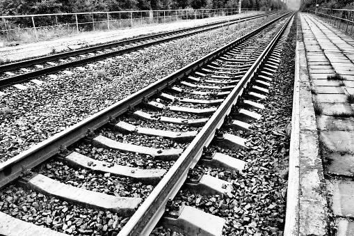 Railways. Metal steel rails and wooden sleepers. Rivets and fasteners on the railroad. Stony backfill of railway tracks. Station Nyrki, Karelia