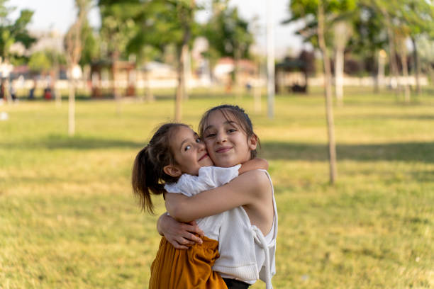 istock Girls spending time in a green field. 1517984844