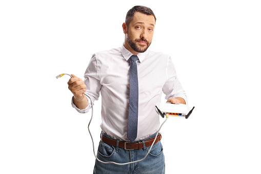 Bored young man holding a router isolated on white background