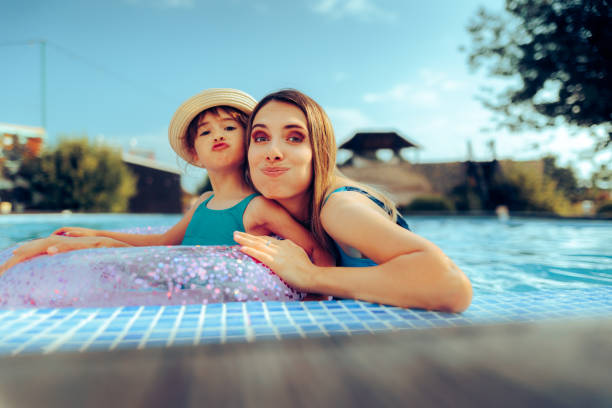 istock Funny Mother and Daughter Making Grimaces at the Pool 1518033181