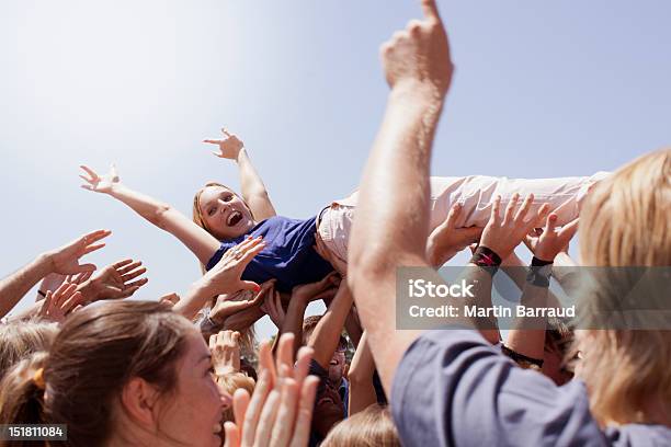Enthusiastic Woman Crowd Surfing Stock Photo - Download Image Now - Crowd Surfing, Music Festival, Music