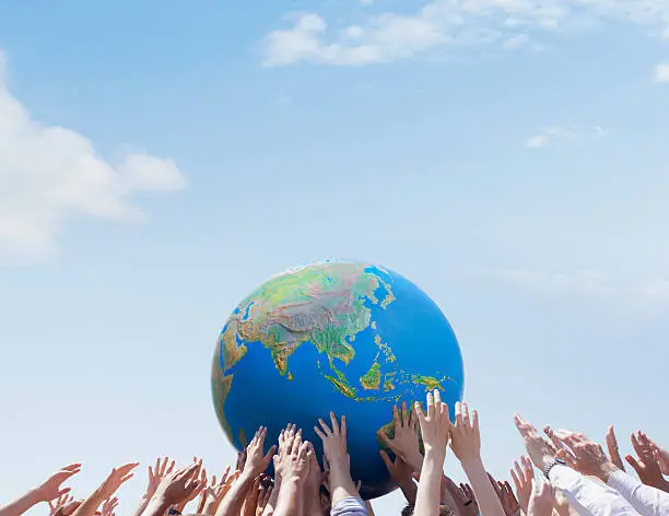 Photo of Crowd reaching for globe