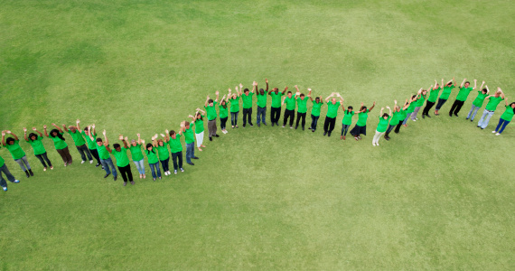 Background of diversity human bare hands join together in the middle under with warm natural sun light, Concept power of social network or volunteer's to be unity help and support the network society.