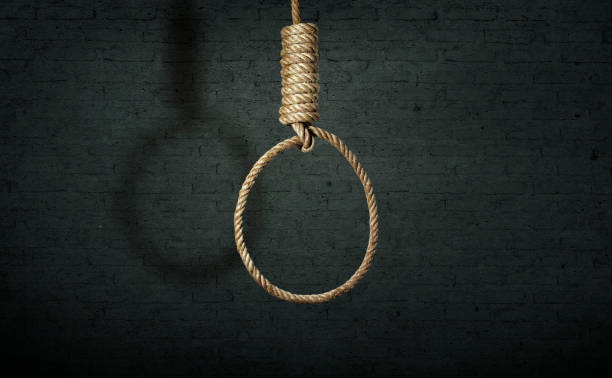 istock suicide concept. noose with shadow on dark wall background 1518178244
