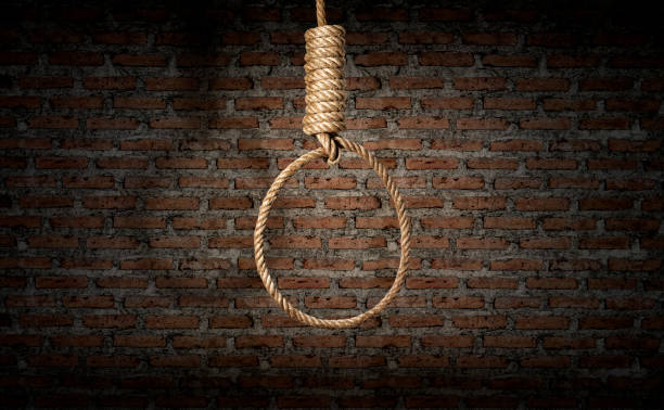 istock suicide concept. noose with shadow on dark brick wall 1518179345