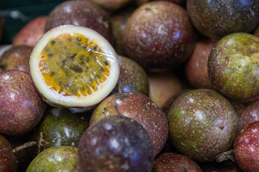 Passionfruit sliced on display on a grocery rack