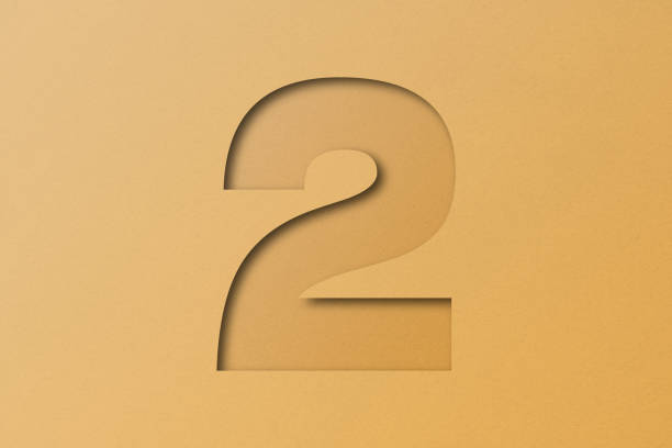 istock White paper type paper alphabet number 2 isolated on orange background. 1518260572