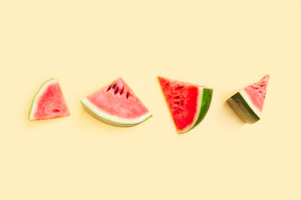 istock Watermelon fruit sliced isolated on yellow background, Organic fruit, Watermelon pieces 1518281848