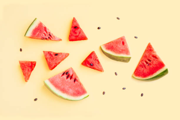 istock Watermelon fruit sliced isolated on yellow background, Organic fruit, Watermelon pieces 1518281851