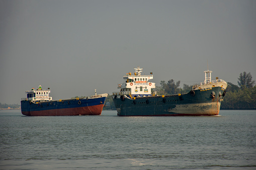 11th February, 2023, Sundarban, West Bengal, India: A cargo ship carrying cargo from Bangladesh to India on river at Sundarban Tiger reserve, India.