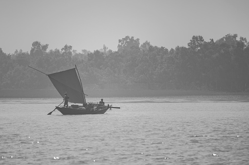11th February, 2023, Sundarban, West Bengal, India: A fisher man family going for fishing with their sailing country boat at Sundarban Tiger Reserve.