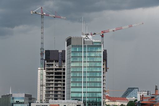 View of the city buildings under construction with cranes. Cityscape. Andersia Poznań