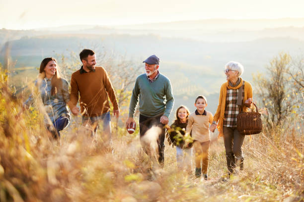 istock Happy multi-generation family going on a picnic in autumn day. 1518436663
