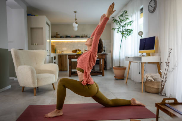 istock Beautiful Woman Practicing Yoga at Home 1518450957
