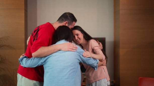 istock Participants of group therapy session hugging each other after finishing group therapy session 1518460573