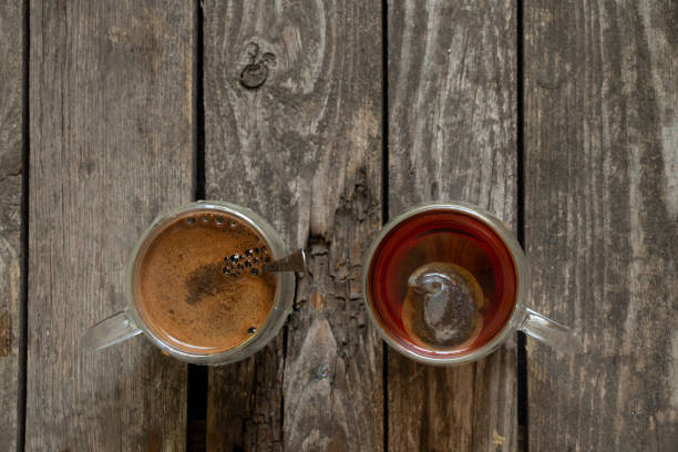 istock two cups with coffee and tea are on a wooden table 1518484577