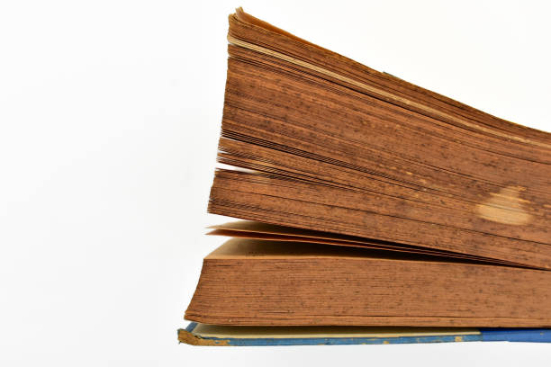 istock close up brown old book isolated on white background, vintage style 1518489347