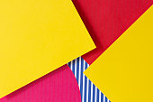 Texture background of fashion papers in Memphis geometry style. Yellow, blue, pink, white colors composition with striped lines pattern paper. Top view, flat lay