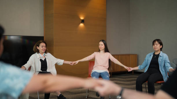 istock Group therapy session participants meditating before starting therapy session 1518491458