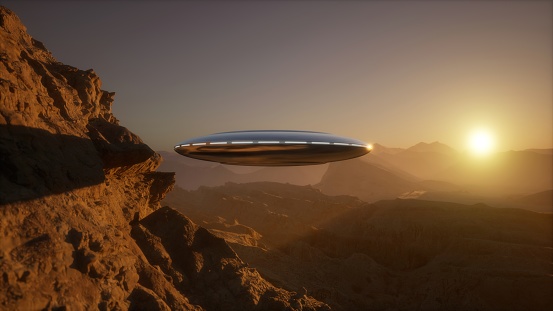 Emerging from behind the towering mountain, a UFO dish soars through the sky with incredible speed and grace. Its sleek, metallic structure gleams under the sunlight as it defies the laws of gravity, leaving a trail of mystifying wonder in its wake.