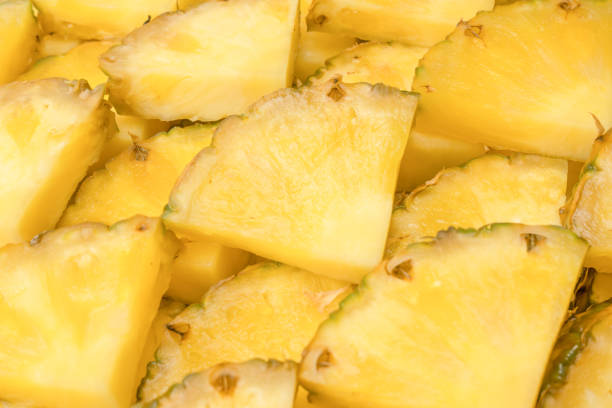 istock Pineapple juicy yellow slices as a background. 1518498163