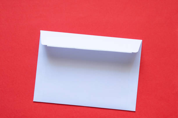 istock paper white mail envelope lies on a red background close up 1518499715