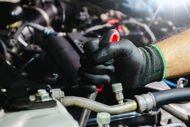 istock Auto mechanic hands in black gloves repairing a car engine 1518557263
