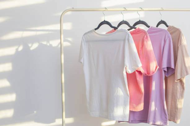 istock women's t-shirts on  hanger on  white background 1518563002