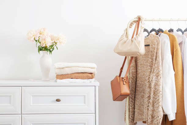 istock female clothes on hangers  in  white room 1518563012