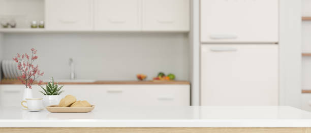 istock Close-up image of a copy space on a white kitchen tabletop in a modern white kitchen 1518568558