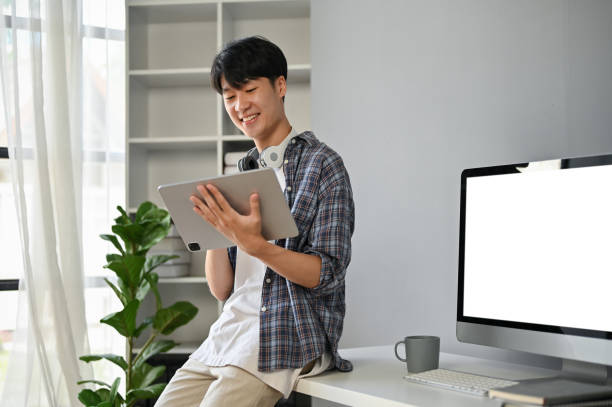 istock A smart Asian male programmer or freelancer using his digital tablet in the office. 1518580977