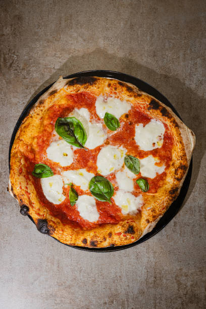 Directly above round freshly baked pizza Margherita stock photo