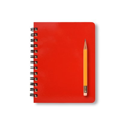 Overhead shot of closed red spiral notebook with yellow pencil, isolated on white with clipping path.