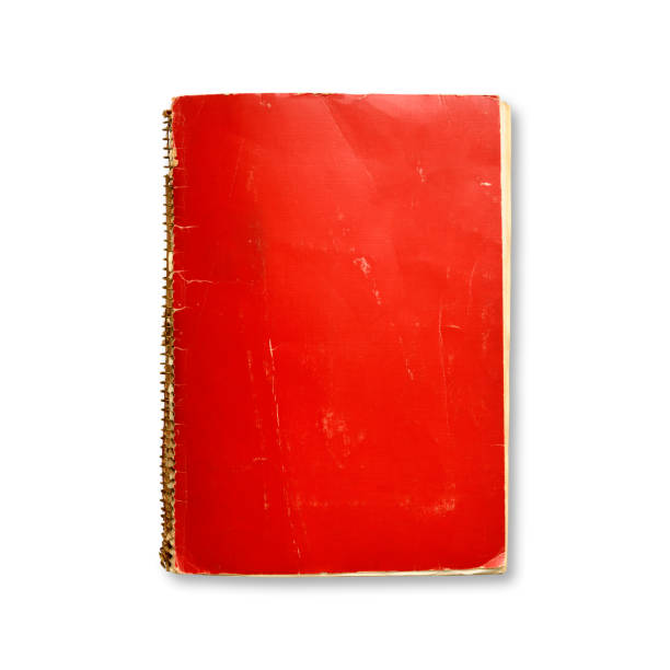 istock Isolated shot of closed old red spiral notebook on white background 1518607722